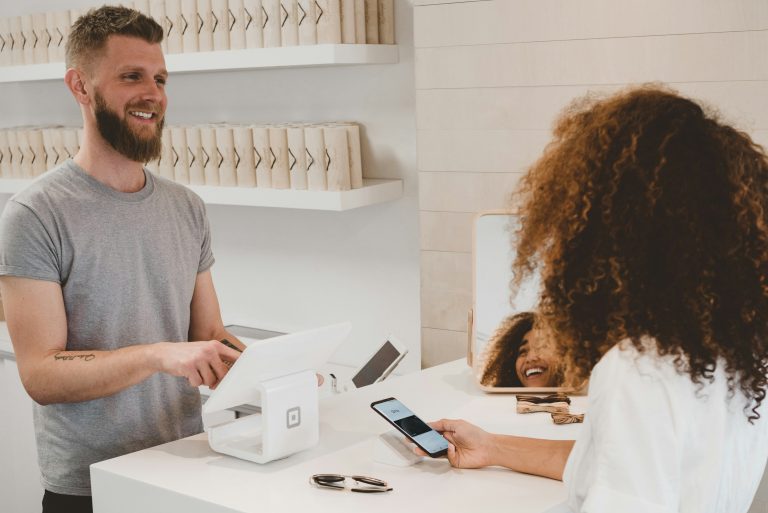 retail employees outsell — salesperson helping customer at store counter